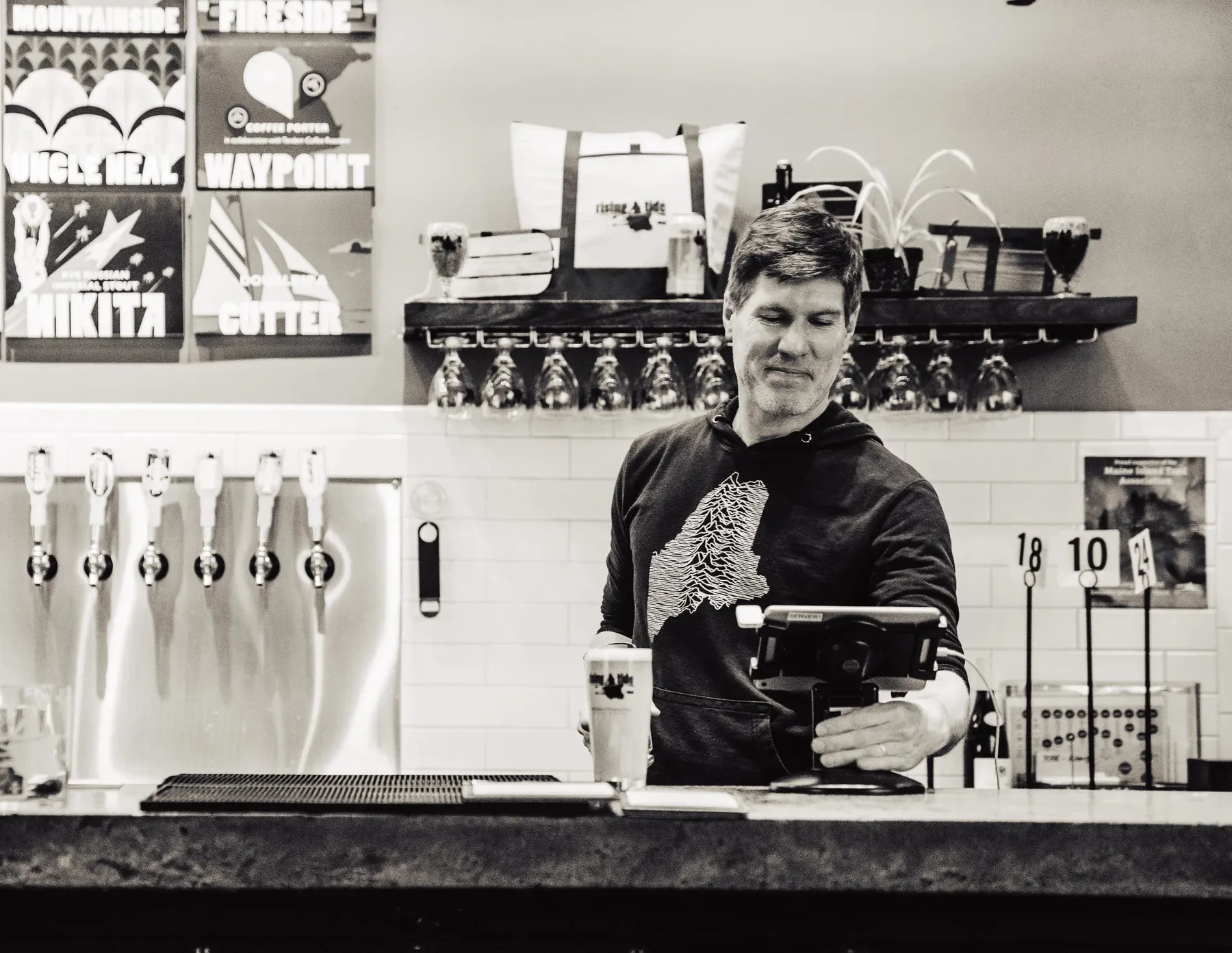Bartender working behind a brewery counter
